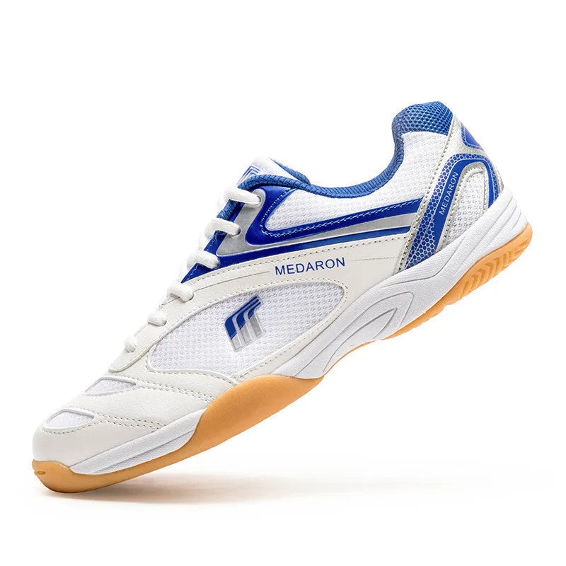 White table tennis sneakers with mesh upper and rubber sole in red or blue accents