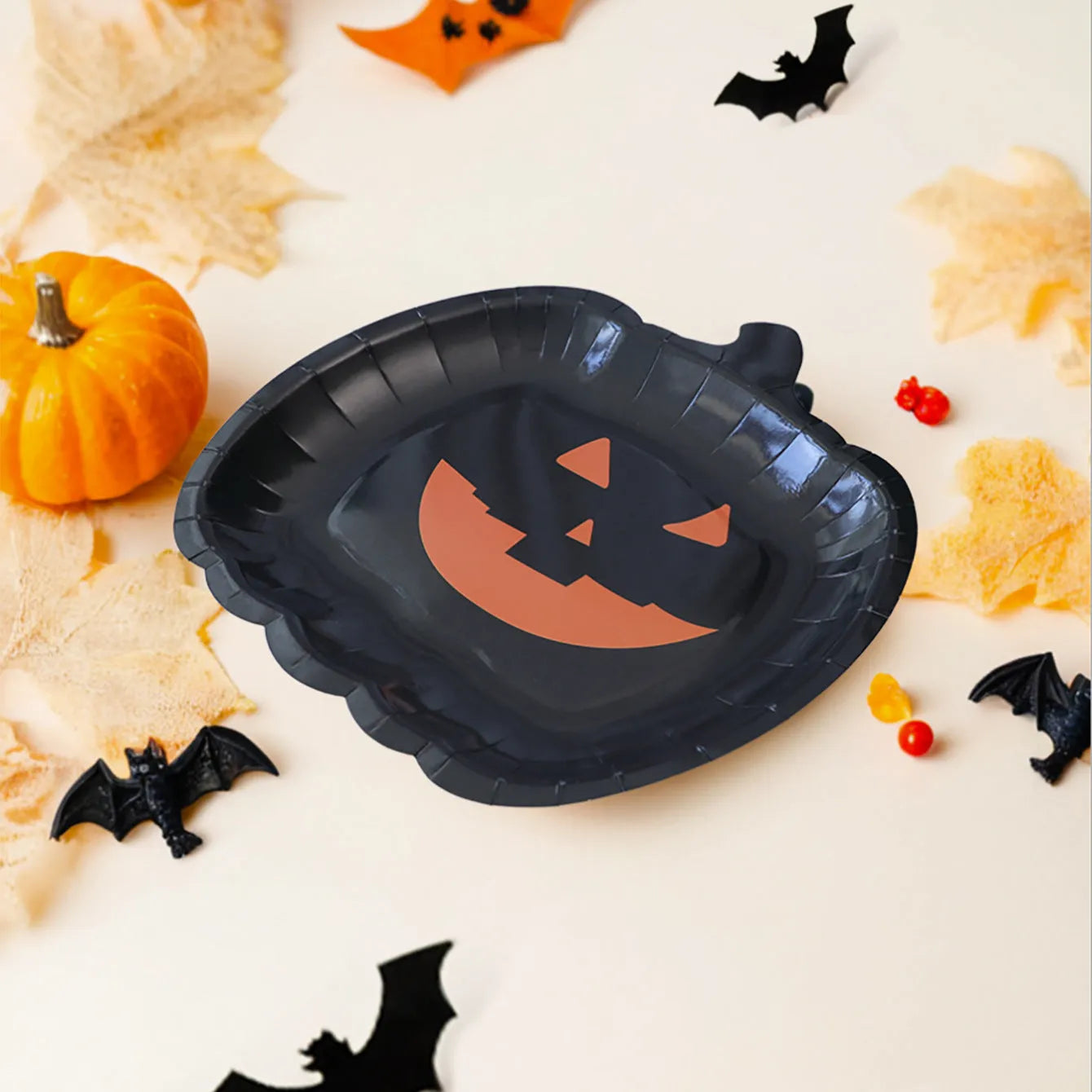 Black Halloween paper plates with pumpkin design measuring 9 inches diameter
