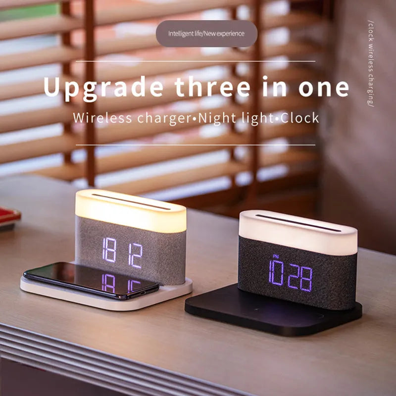A compact black wireless charging table lamp with a digital clock display and integrated night light on a wooden desk.