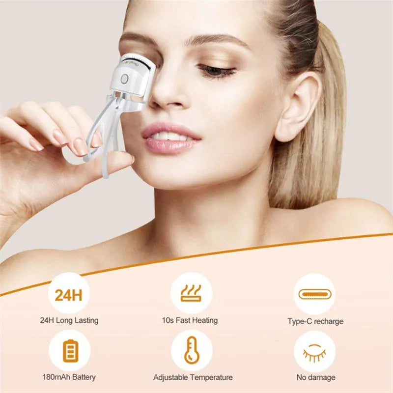 White USB rechargeable heated eyelash curler with dual temperature lights, shown next to its charging cable.