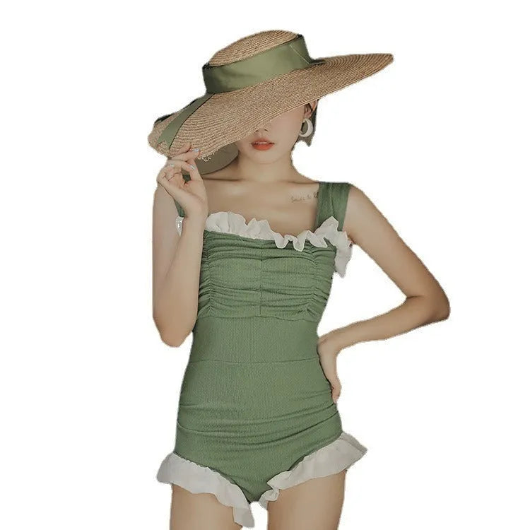 Women's high-waisted one-piece swimsuit in quick-dry polyester, shown in black, green, and pink.