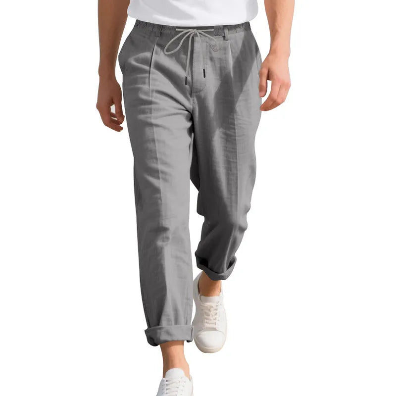 Men's linen casual trousers in a straight-leg style with drawstring waist, shown in a summer colour option.