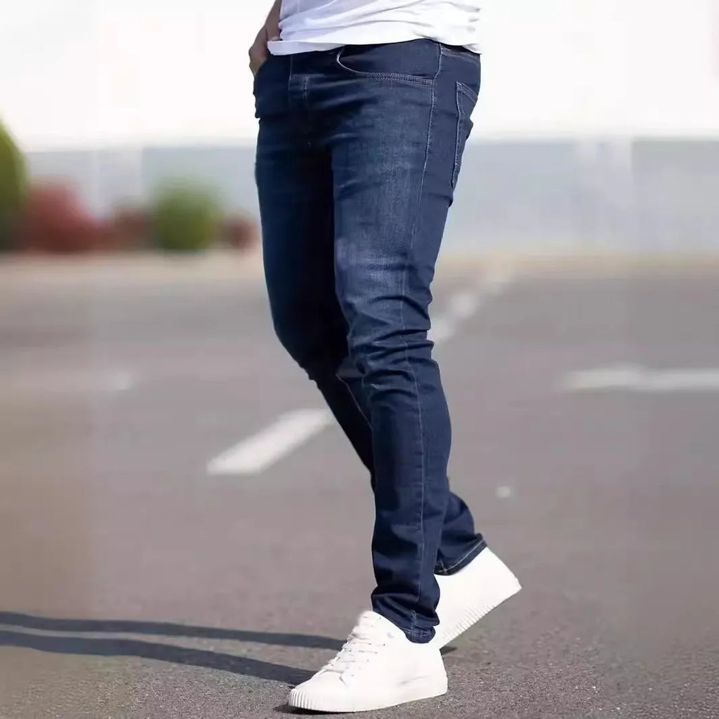 Men's dark blue slim fit casual jeans with a mid-waist and skinny leg style.