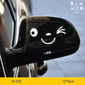 Pair of reflective cartoon car stickers with cute eye designs on a white background.