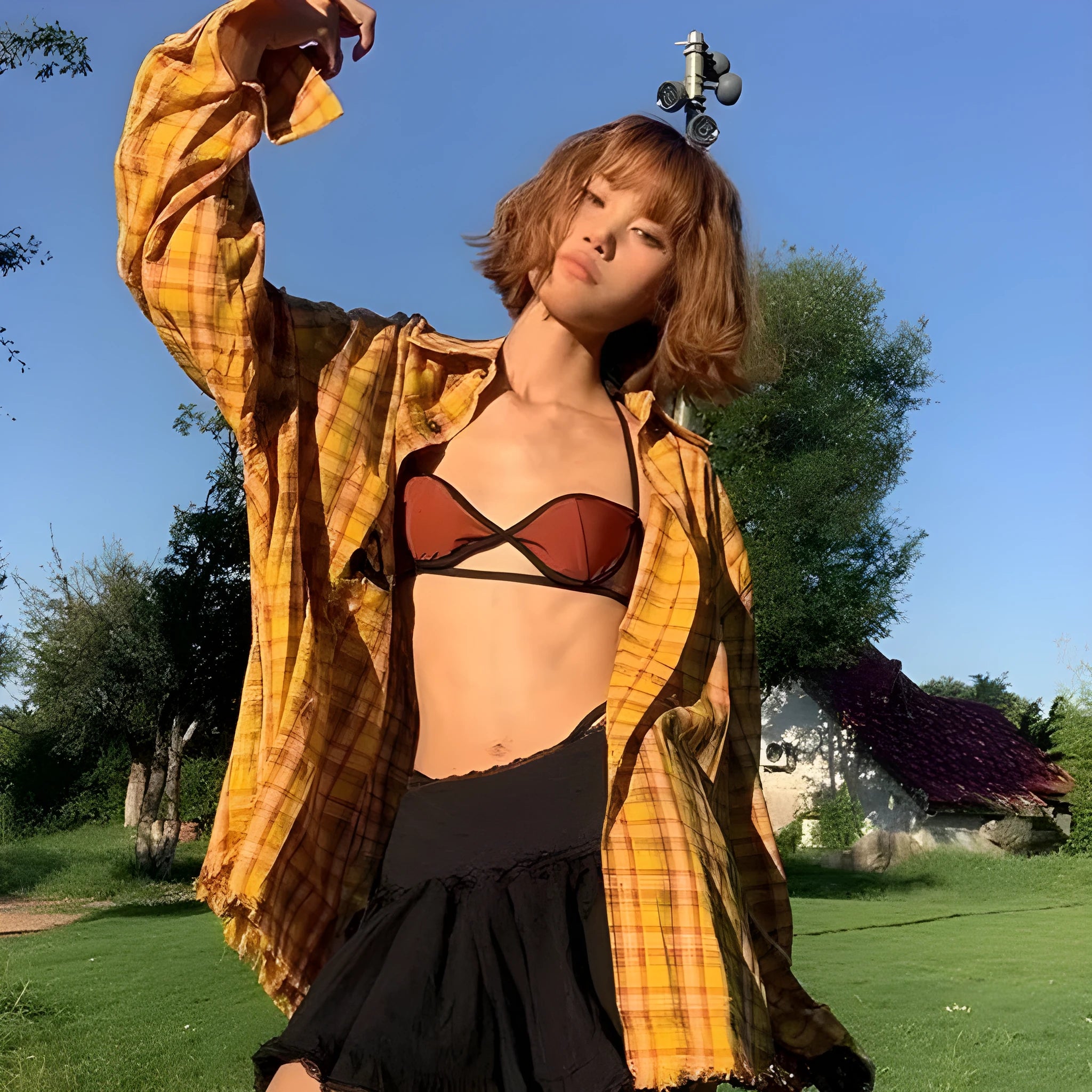 Yellow and black plaid shirt with a loose cardigan-style fit on a hanger.