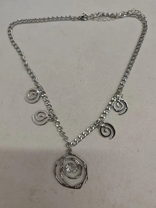 Spiral donut jewellery set showing necklace, bracelet and ear hooks with geometric circle design