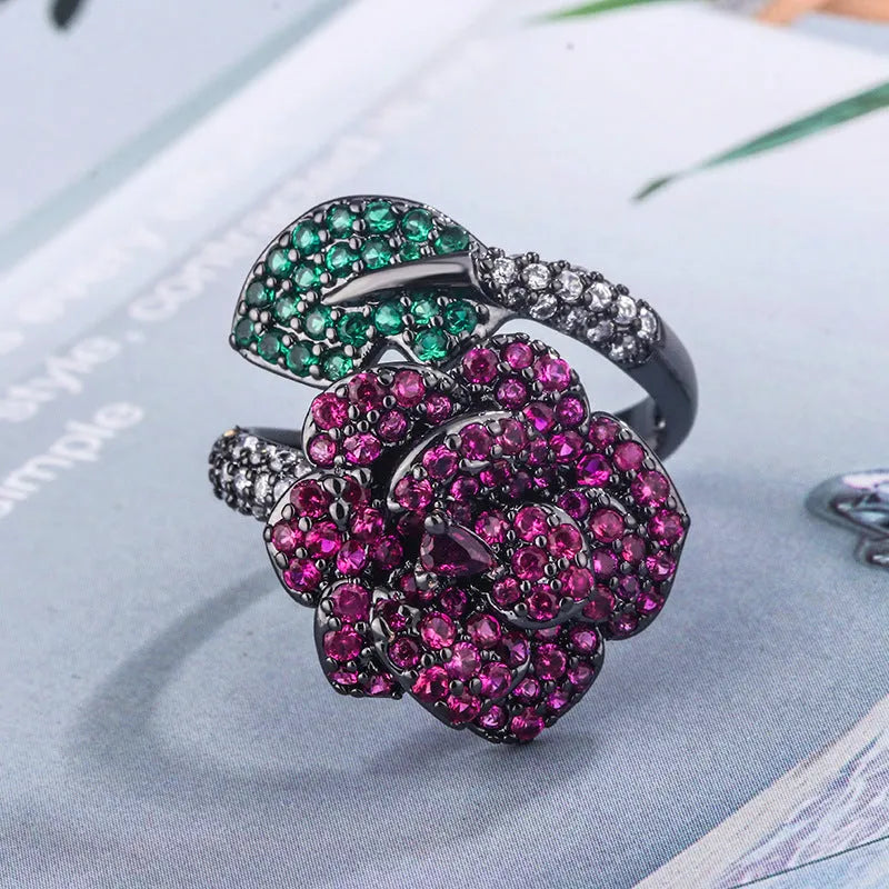 Geometric black gold flower ring with simulated red corundum centre stone