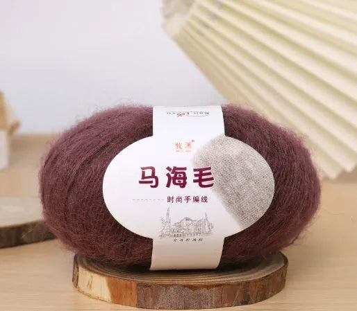 A ball of hand-woven mohair wool yarn for a DIY scarf knitting kit in one of 34 available colours.
