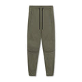 Man in loose grey fitness trousers with tied ankle cuffs, suitable for exercise.