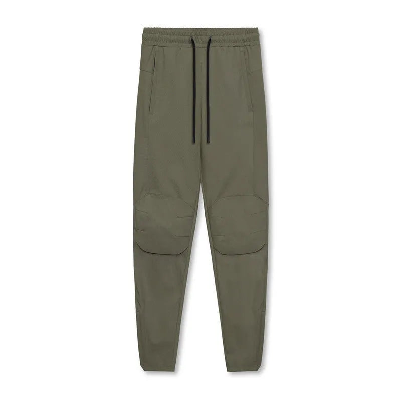 Man in loose grey fitness trousers with tied ankle cuffs, suitable for exercise.