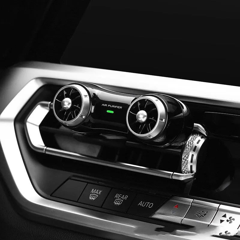 Black and white compact car air purifier and aromatherapy diffuser unit with USB Type-C cable.