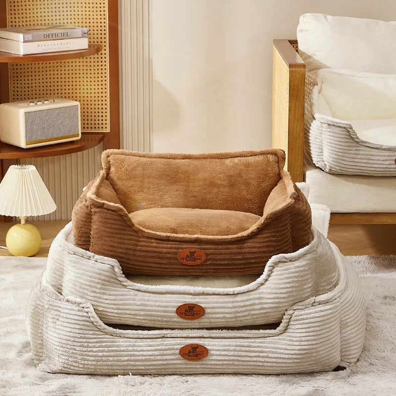 Coffee and white coloured removable washable dog kennel bed shown in small and medium sizes on a sofa and floor.