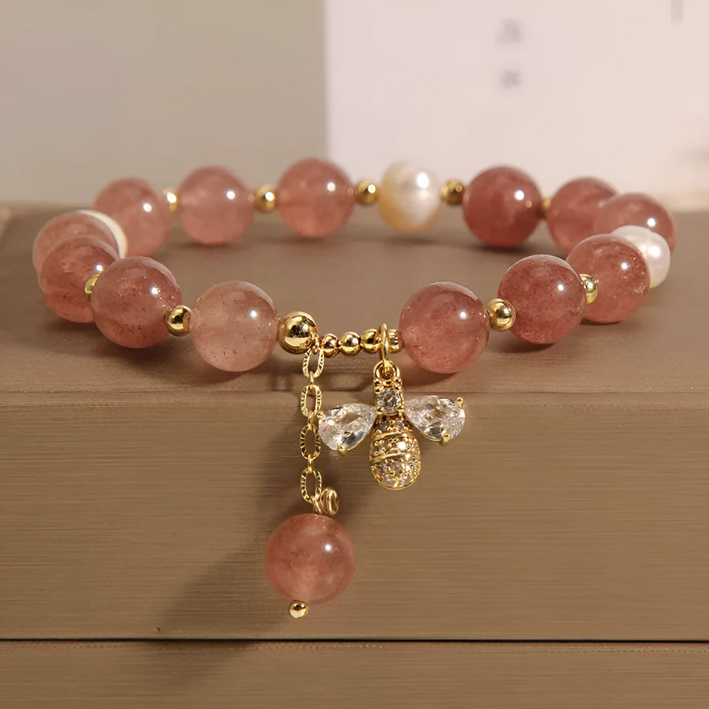 Women's bracelet with pink strawberry quartz stones, white freshwater pearls, and zircon details on an alloy chain.