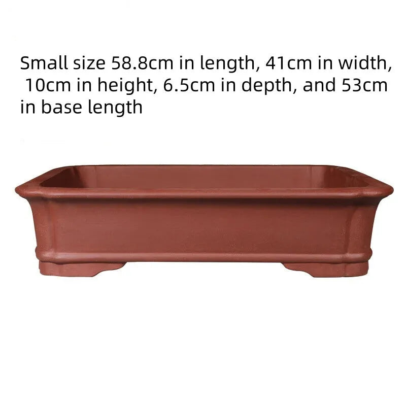 Large rectangular handmade purple clay flowerpot shown in a garden setting.