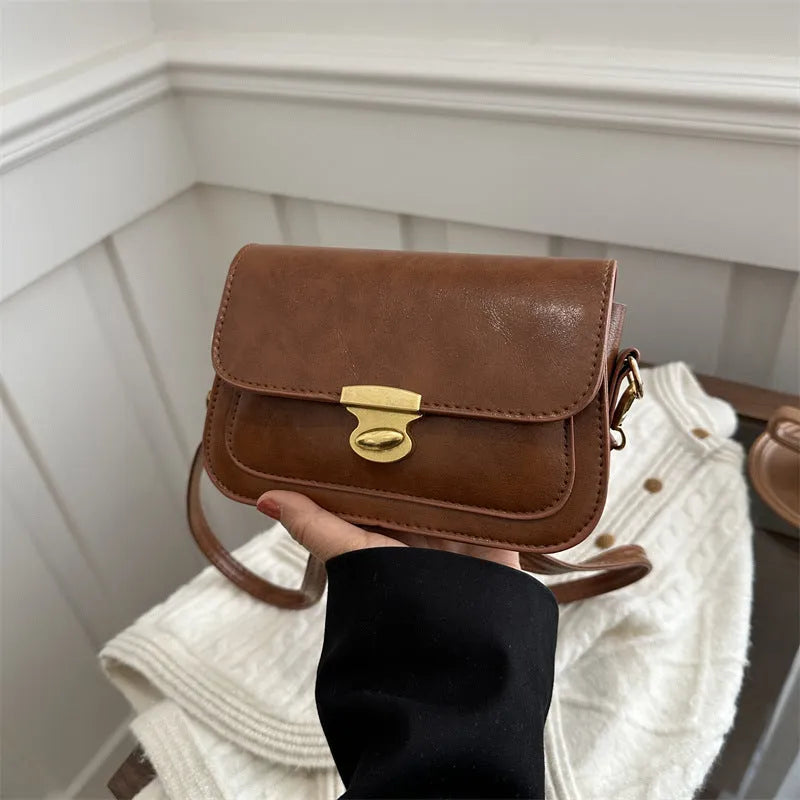 Soft PU leather small square handbag in horizontal rectangle shape shown in brown colour.