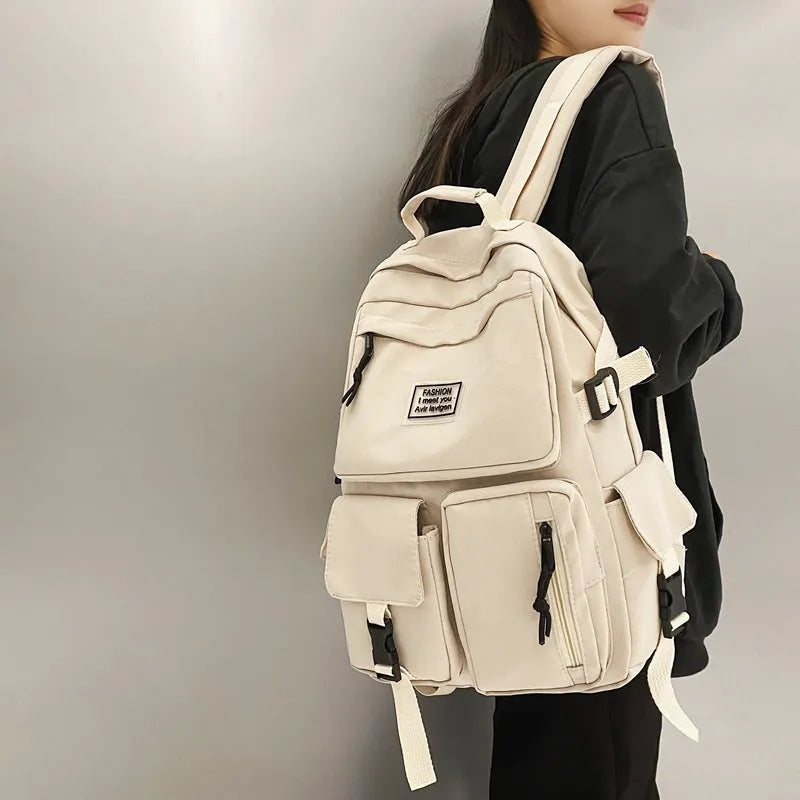 Nylon student backpack in black colour showing laptop compartment and three-dimensional pockets