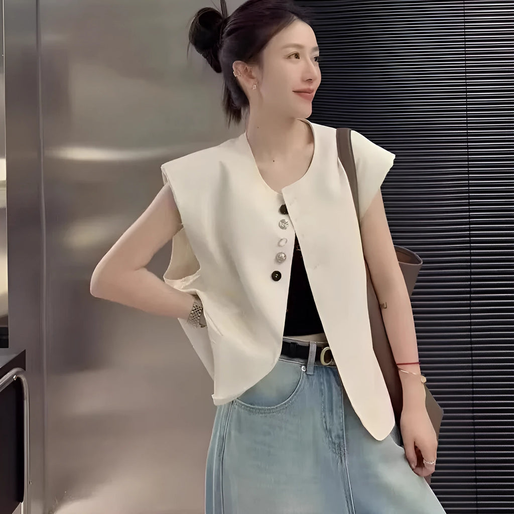 Women's loose fit polyester vest in milky white with a pocket detail and short 40cm length.