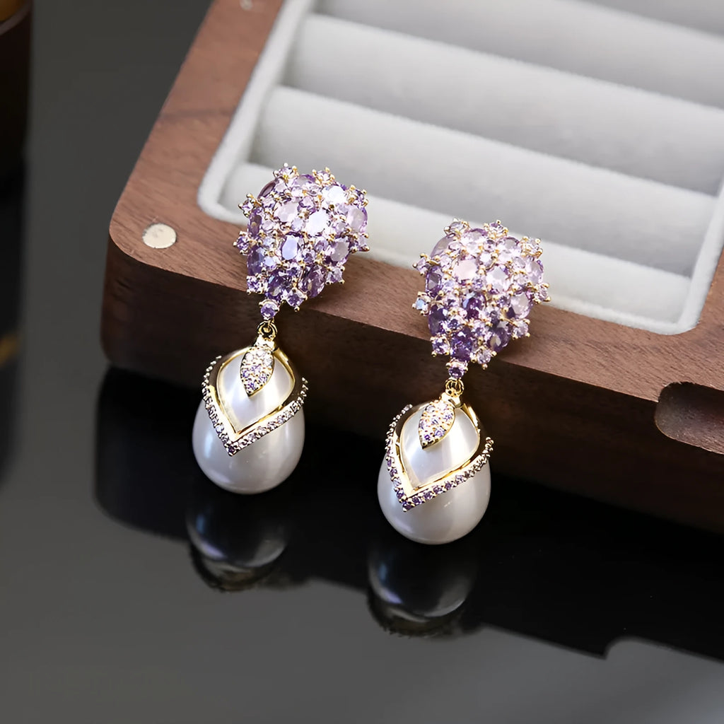Women's drop-shaped earring with a white pearl and purple zircon stones on an 18K gold-plated setting.