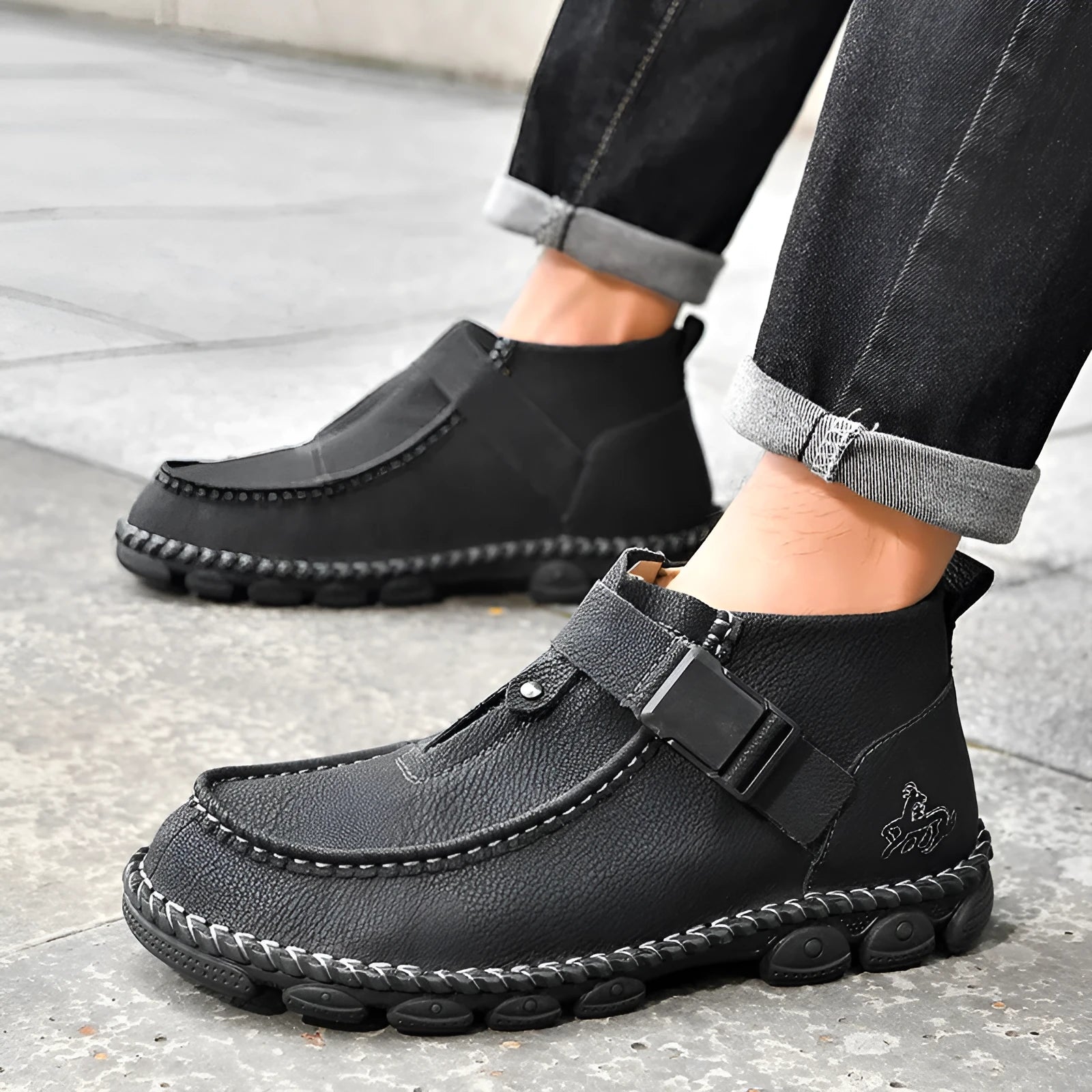 Handmade men's black synthetic leather slip on shoes with a flat heel on a plain background.