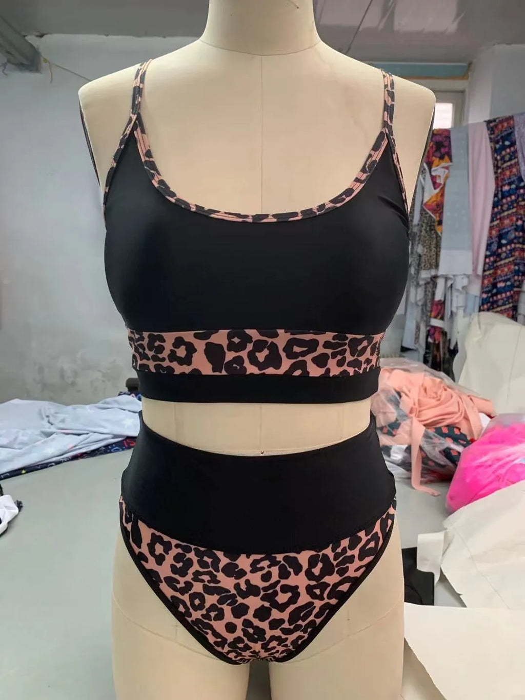 Women's high waisted leopard print bikini set with matching top on a mannequin.