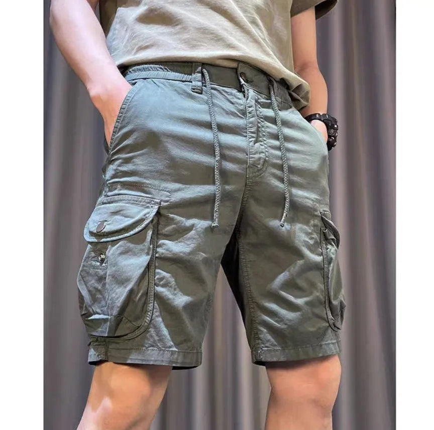 A model wearing loose, straight-leg multi-pocket casual overalls in a khaki colour.