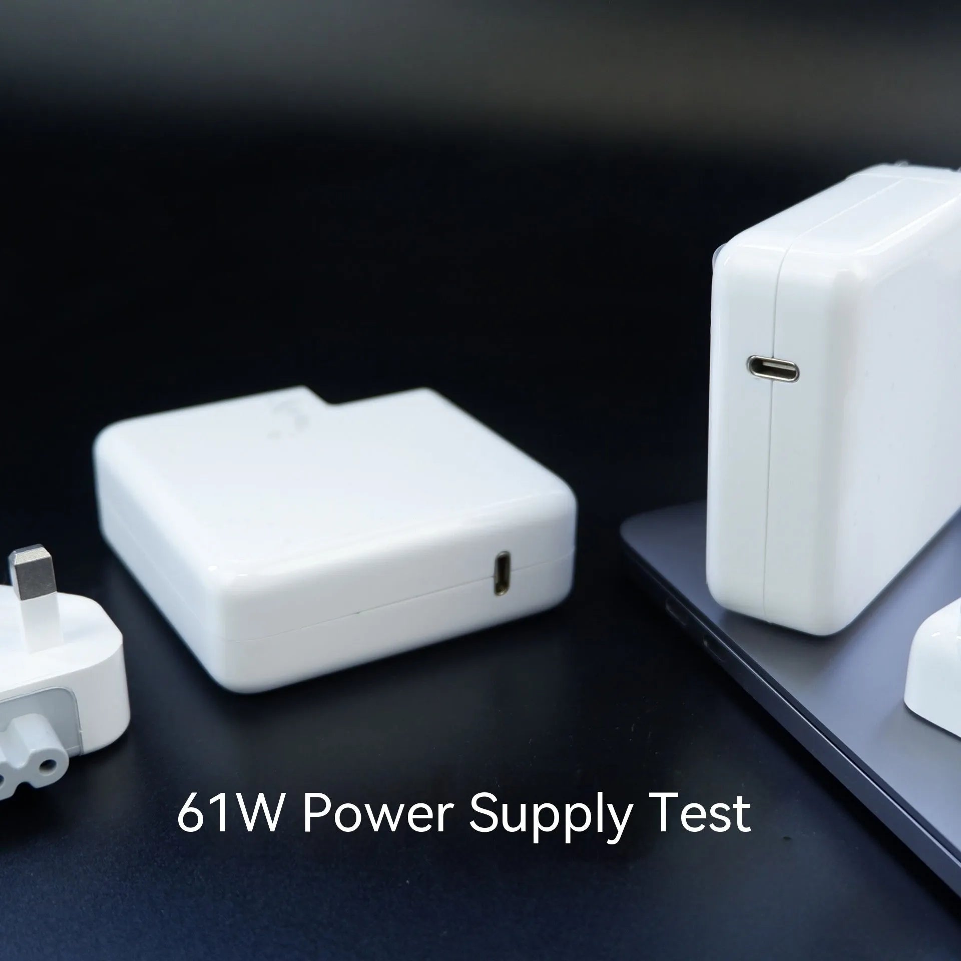 Laptop power adapter with choice of international plugs and a USB-C to USB-C cable.