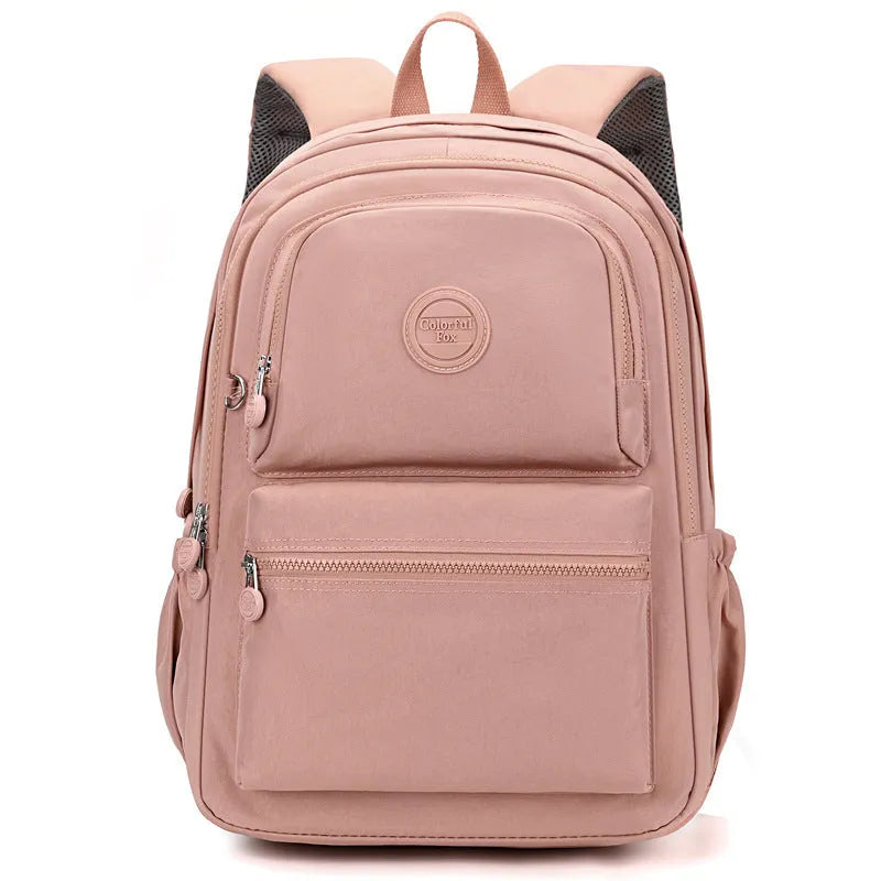 Women's large nylon travel backpack in celestite green showing front three-dimensional pocket and urban style.