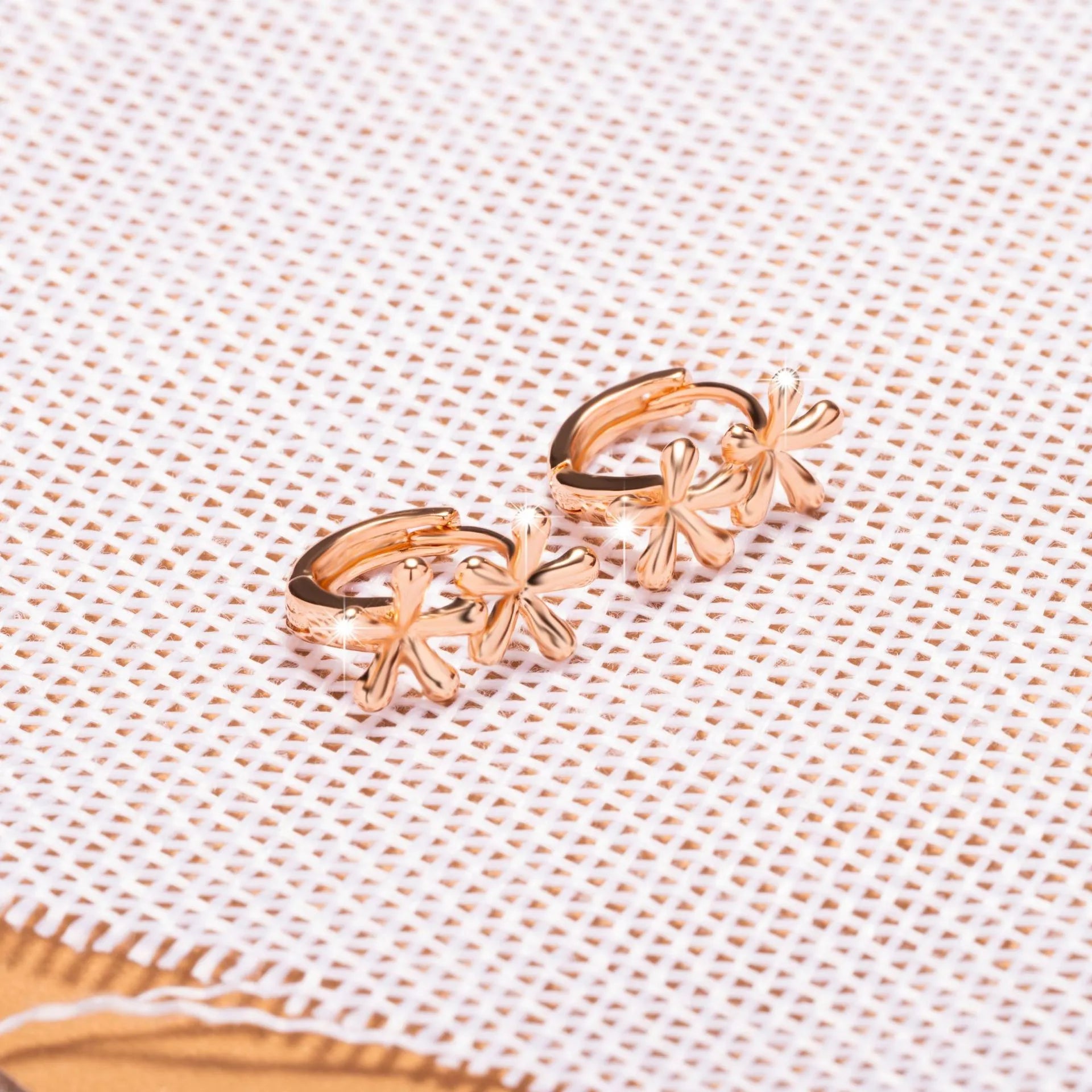 Circular rose gold earrings with a detailed waterdrop flower design for women.
