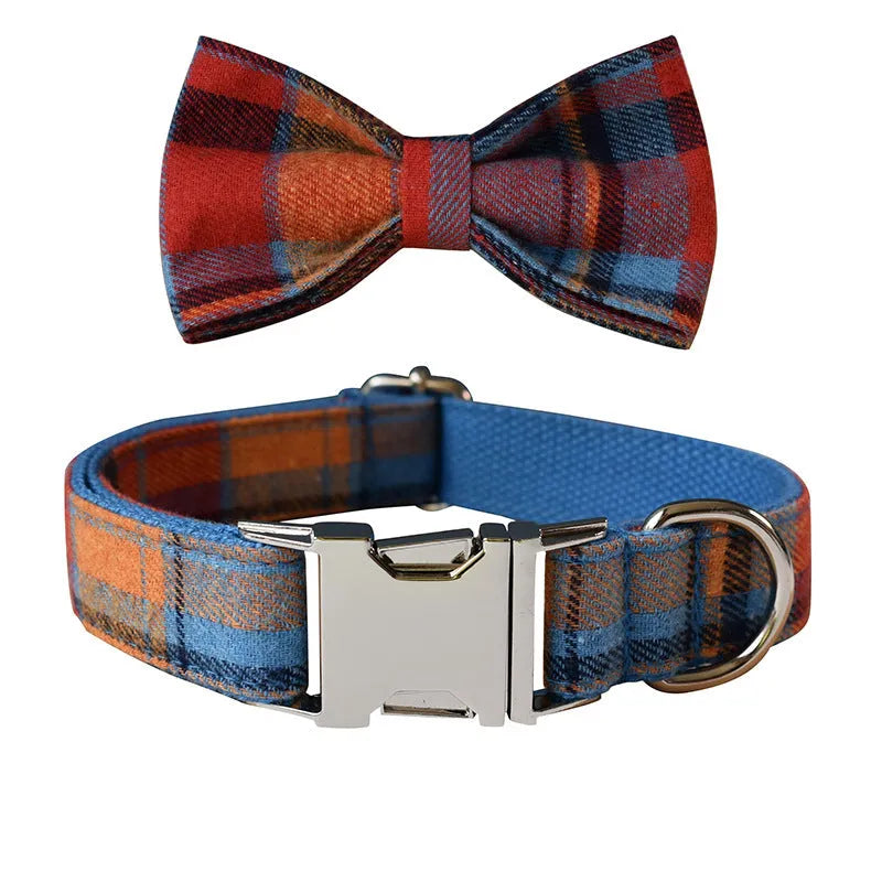 Blue background velvet plaid dog collar with a silver alloy metal buckle on a white surface.
