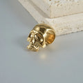 Stainless steel hollow skull Buddha earrings in hip hop style with geometric shape.
