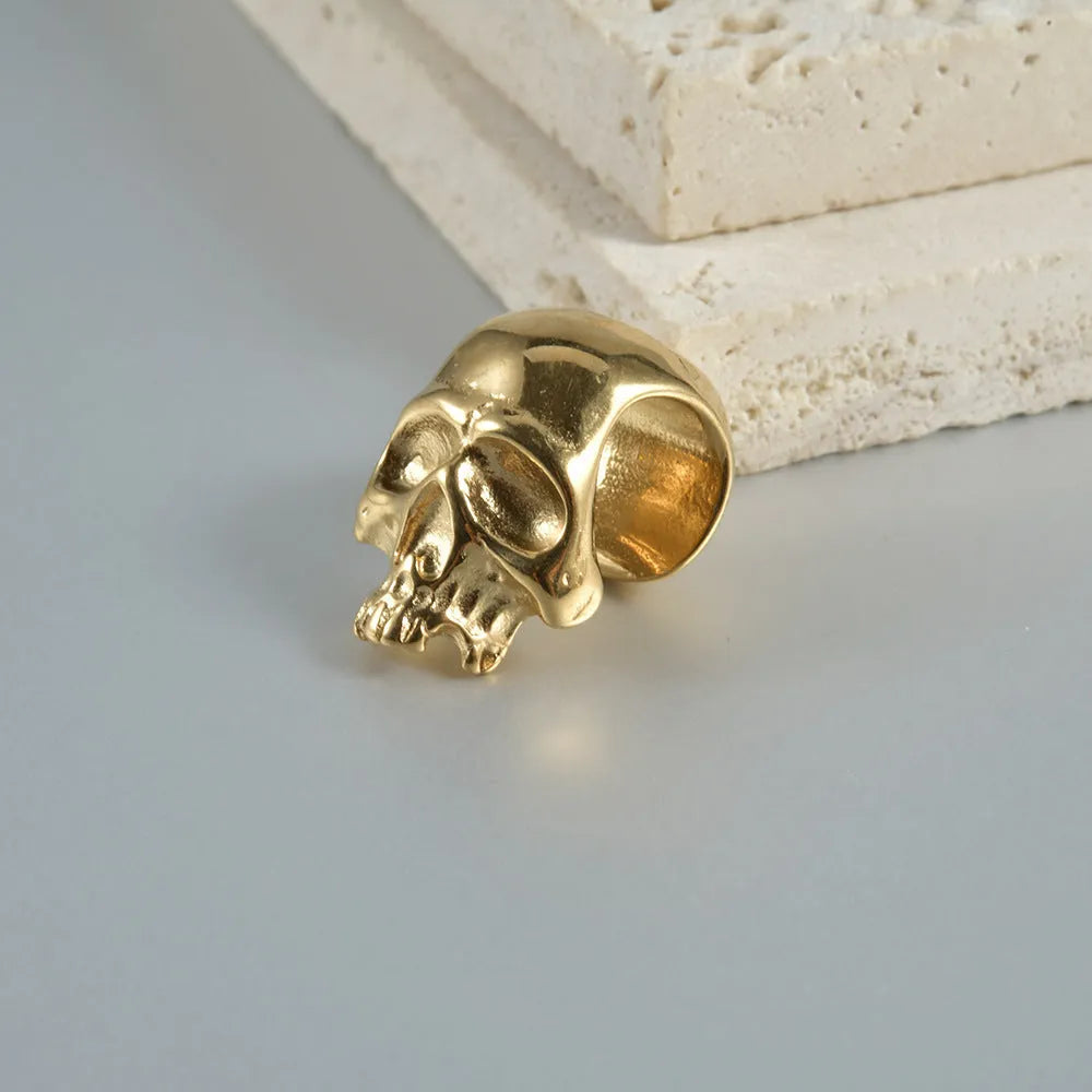 Stainless steel hollow skull Buddha earrings in hip hop style with geometric shape.