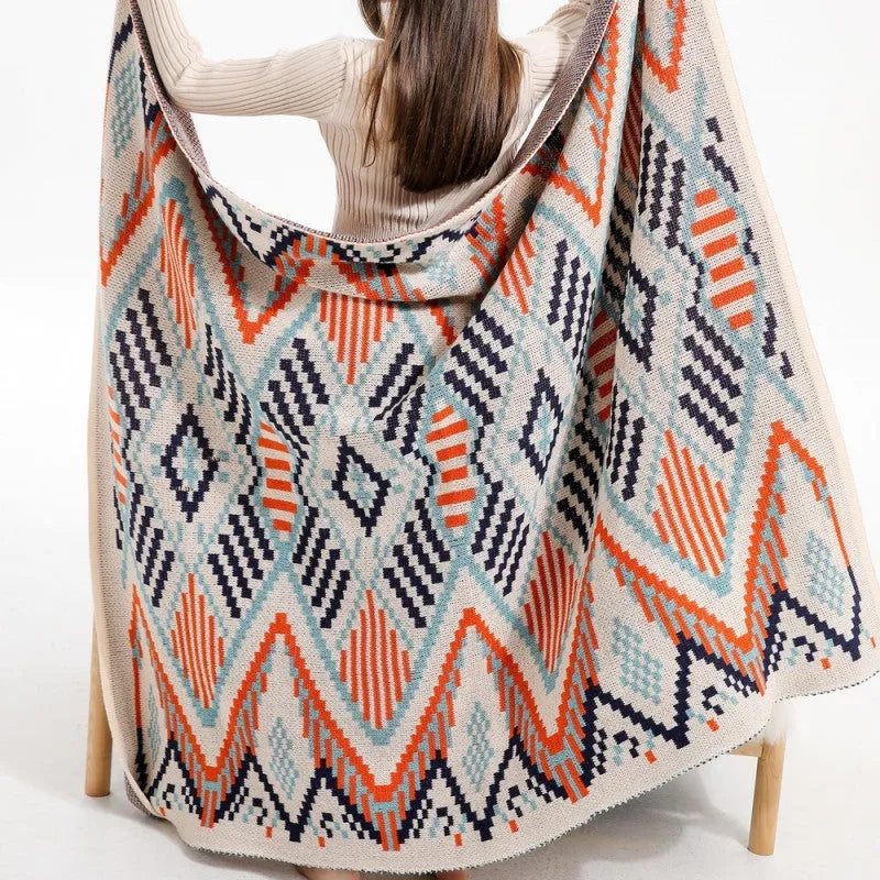 Acrylic bohemian-style blanket with tassel trim in a geometric pattern colour option