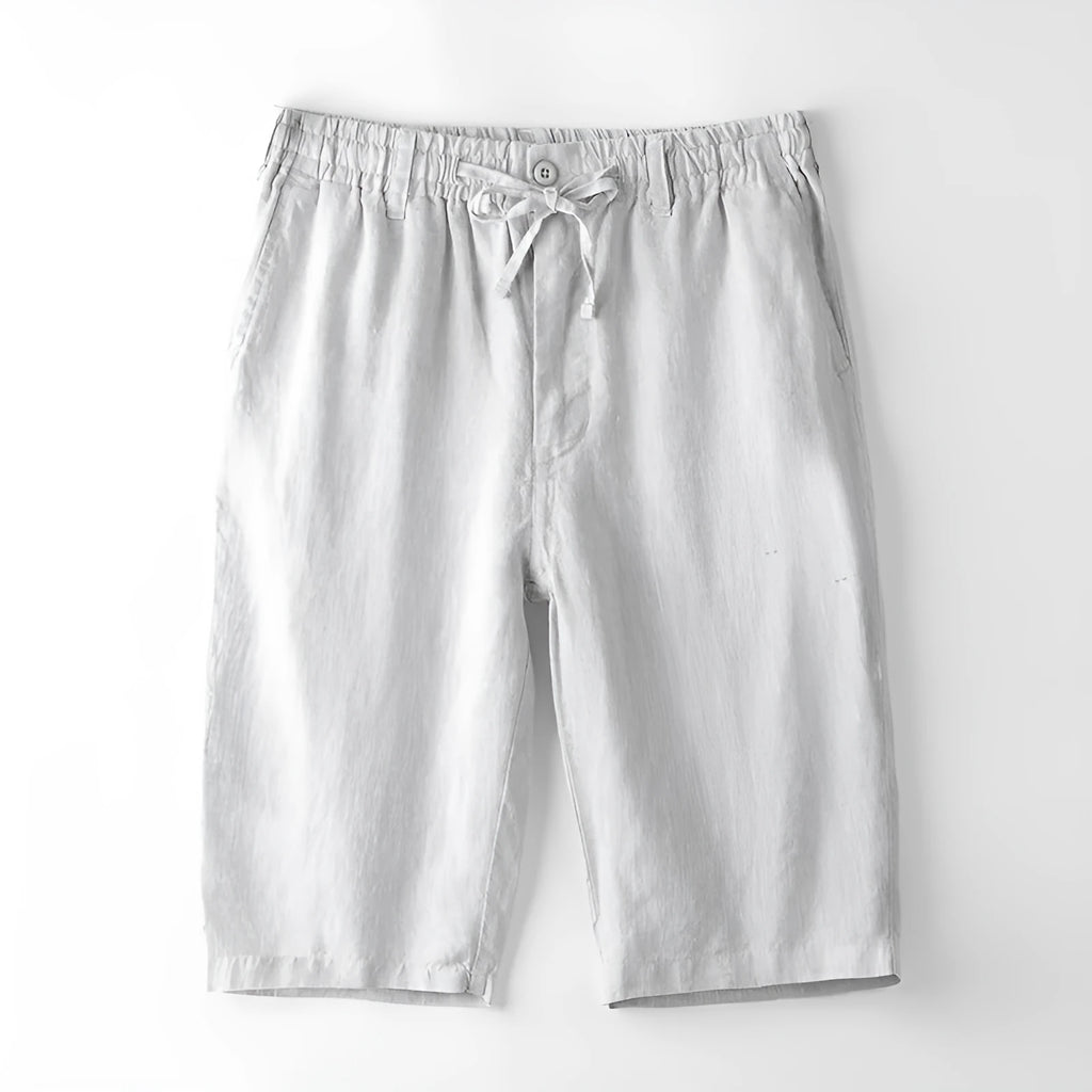 Men's loose-fit linen capri trousers in a straight leg style on a hanger.