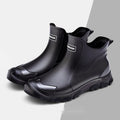 Short tube PVC rain boot in black and red with round toe and flat non-slip sole.