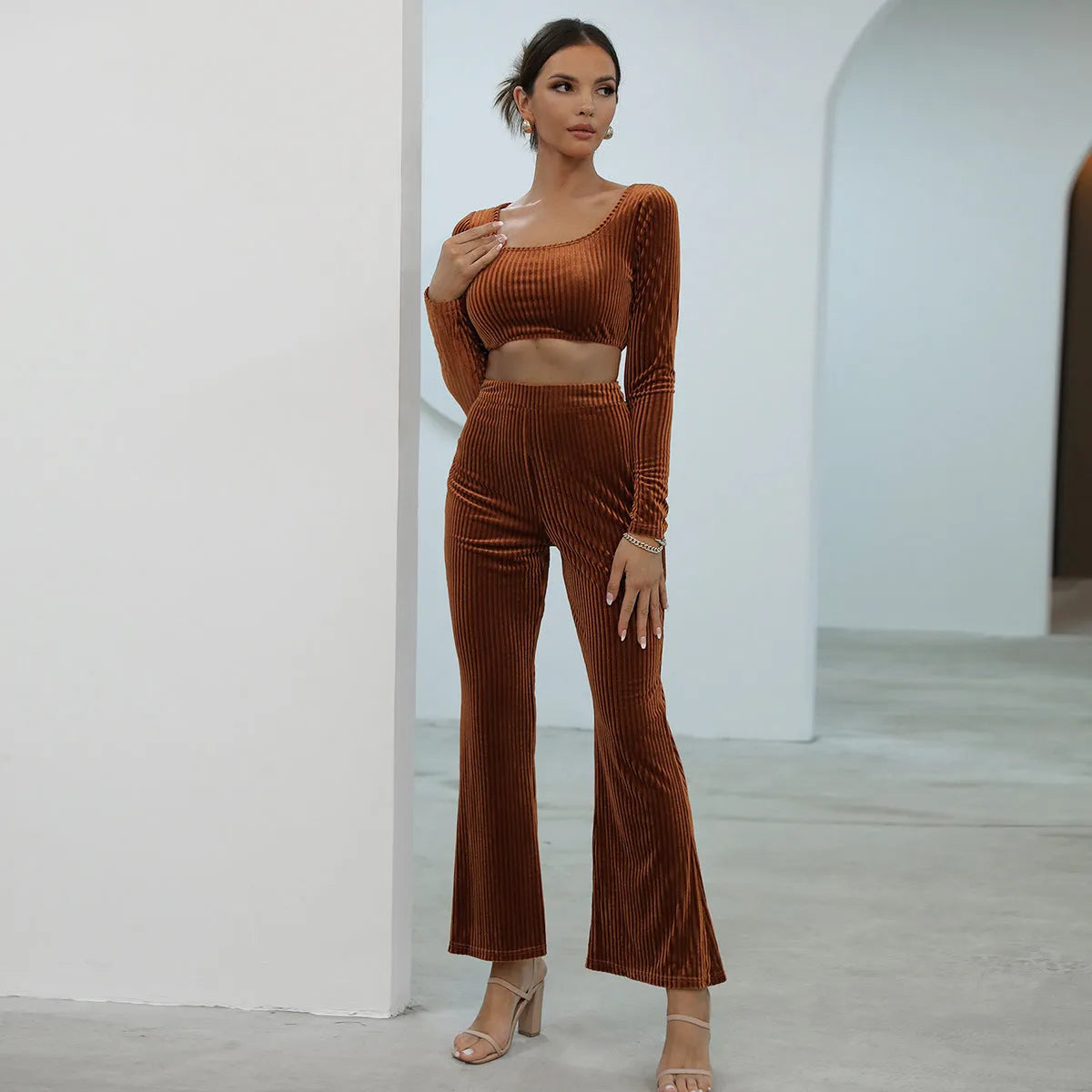 Caramel coloured long sleeve sweater and trouser casual set on a hanger.