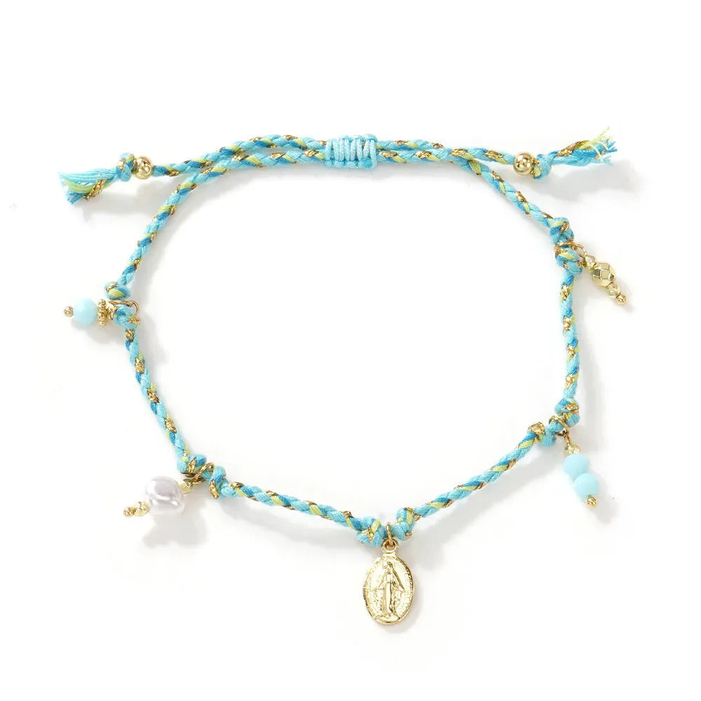 Close-up of a hand-woven ethnic style bracelet for women made from colourful braided rope, showing the strap tag detail.