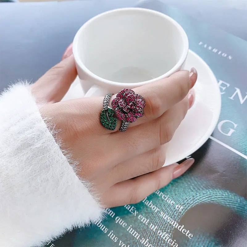 Geometric black gold flower ring with simulated red corundum centre stone