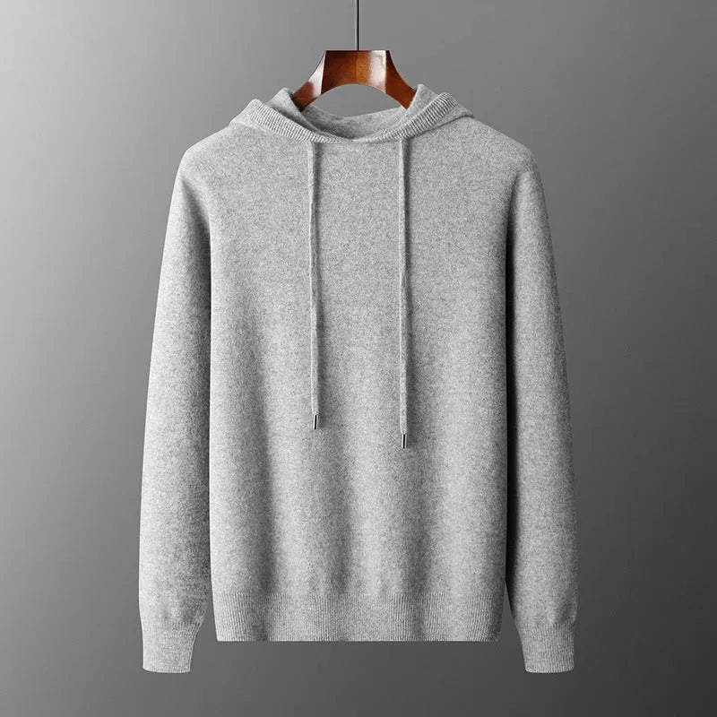 Man wearing a light grey hooded cashmere sweatshirt and matching casual trousers.