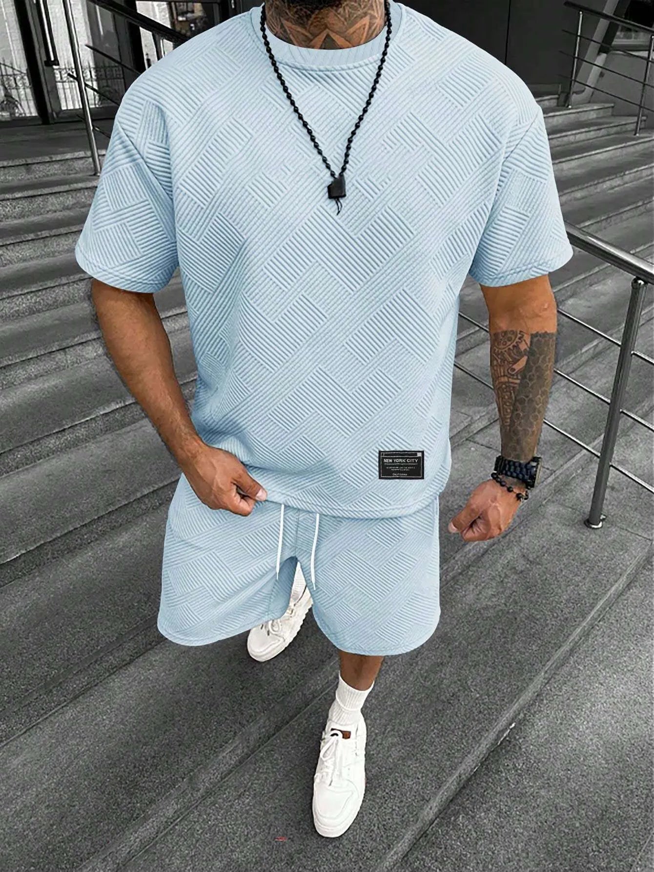 Men's short sleeve top and shorts suit in a polyester blend fabric on a mannequin