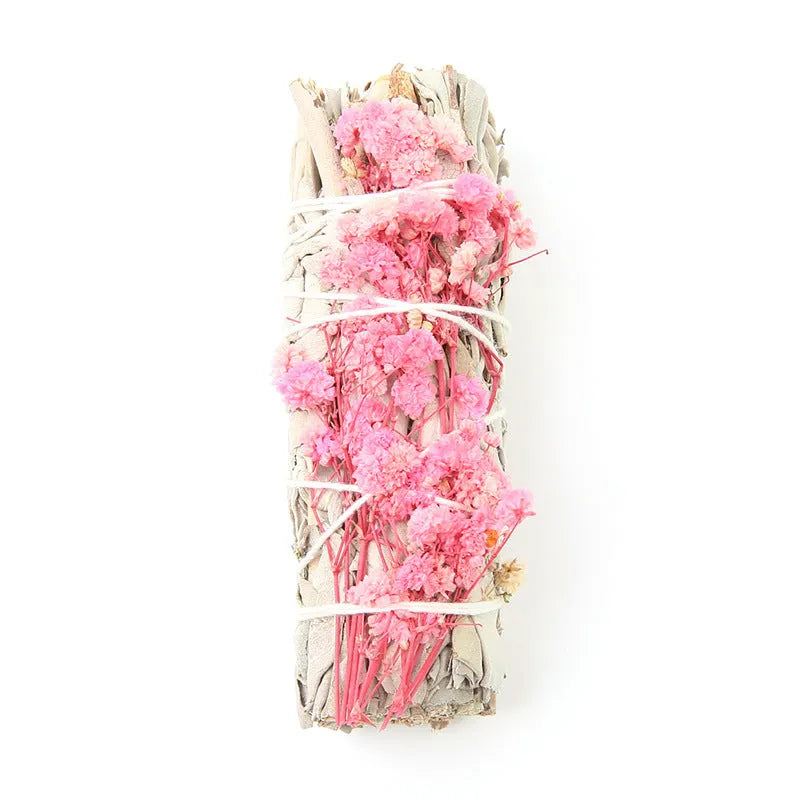 White sage and red rose petal colourful aromatherapy incense bundle on a wooden table