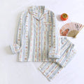 Women's red fruit print cotton gauze long-sleeved top and trousers two-piece lounge set laid flat.