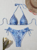 Denim blue printed women's bikini set with strap design on a white background.