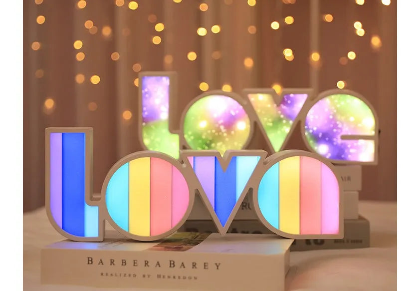 LED Love light with rainbow 'LOVE' lampshade on a table.