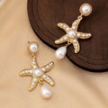 Women's silver-tone pearl starfish earrings on light background