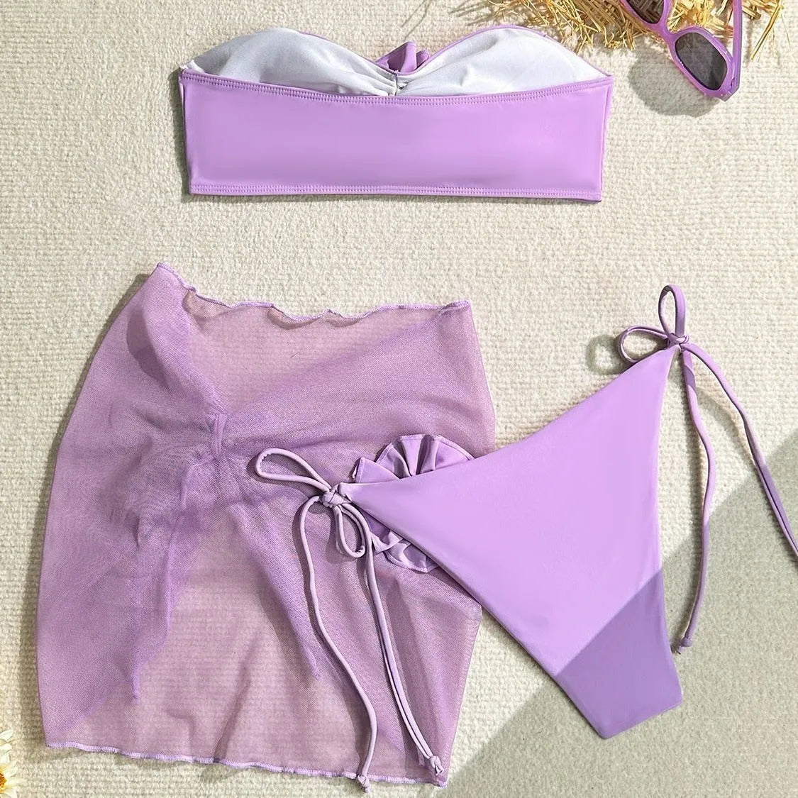 Women's pink tube top swimsuit with a tied flower design, including matching pants and skirt.