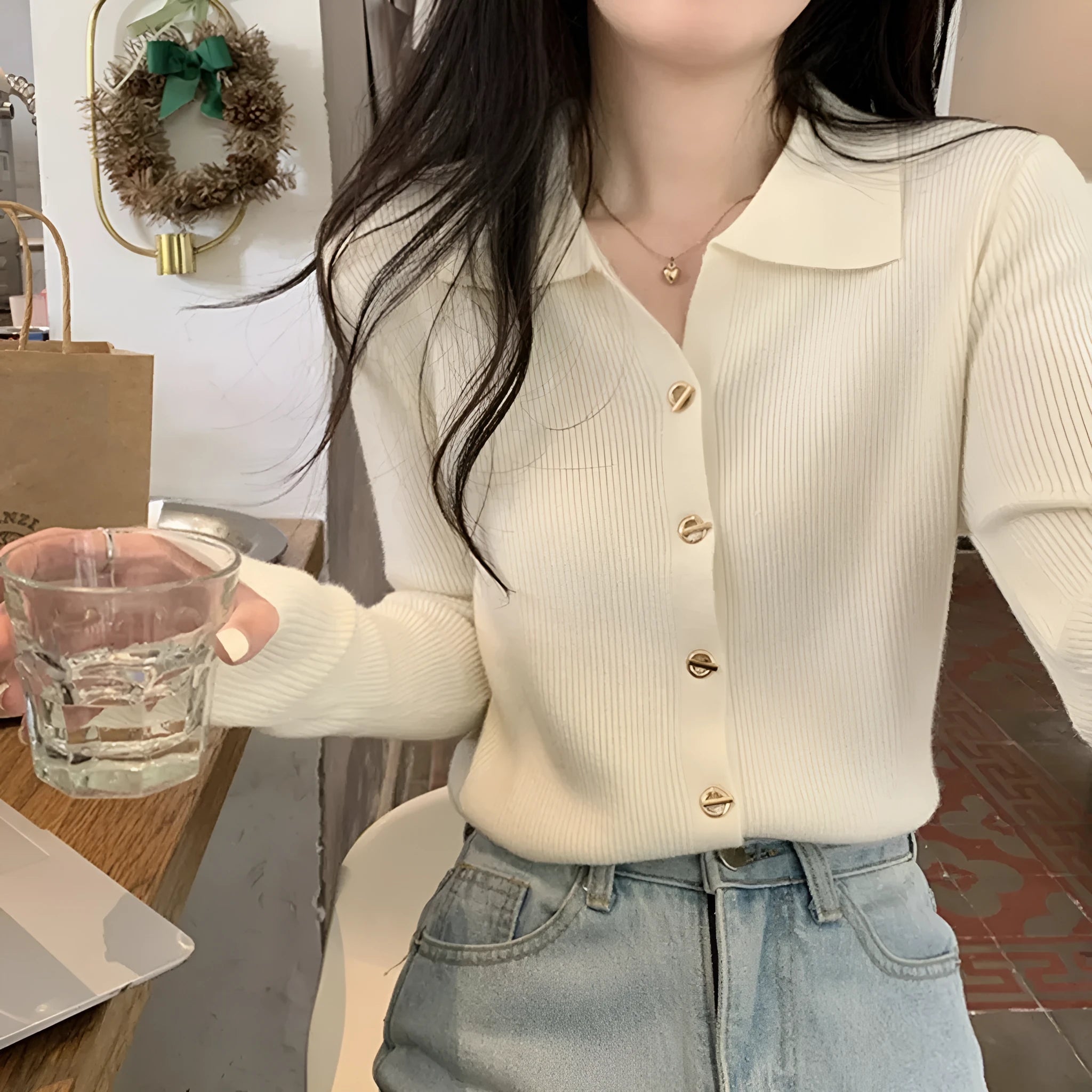 Women's beige knitted cardigan top with long sleeves shown open as a layering piece