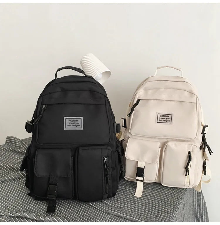 Nylon student backpack in black colour showing laptop compartment and three-dimensional pockets