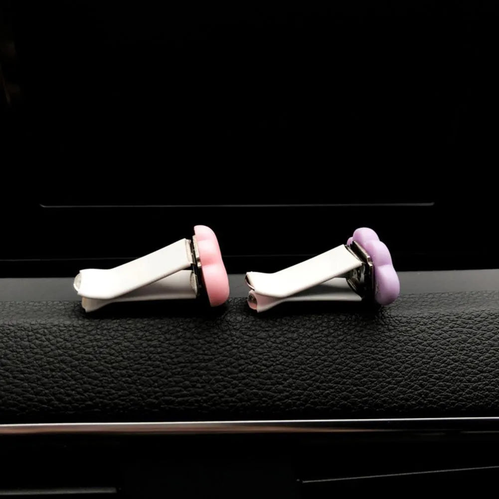 Resin cartoon cloud car air freshener clip in assorted colours on a car vent.
