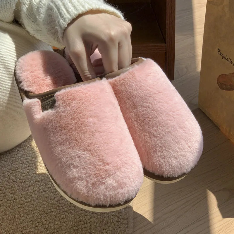 Blue PVC plush winter slippers with non-slip sole on a wooden floor.