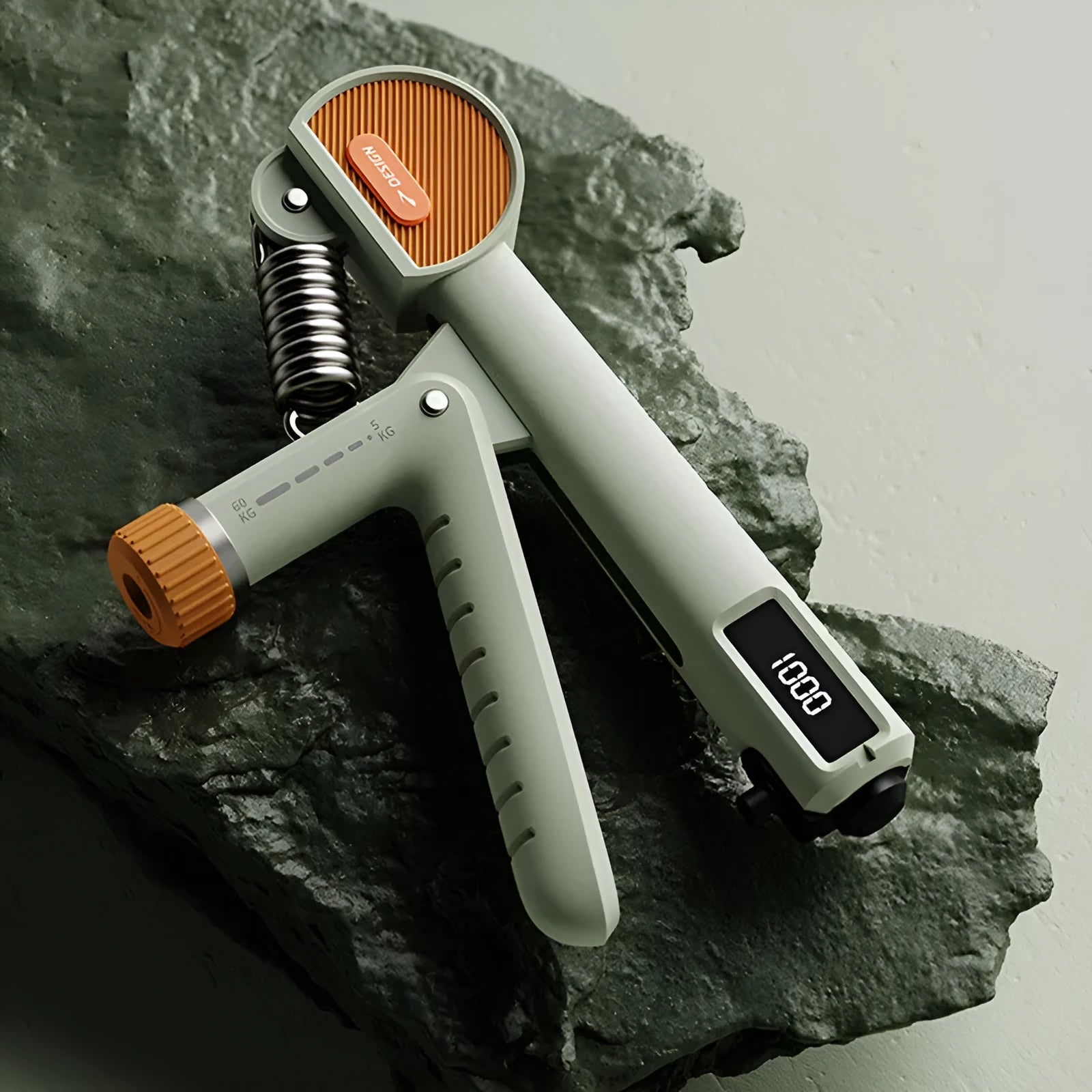 Adjustable spring grip strength trainer in ivory white, black, or green.